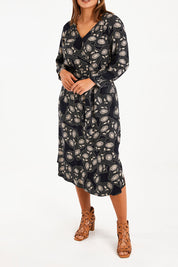 Model Monique wearing size 14 of The Wrap Front Midi Dress in colour Navytaupe (Blue), from the front, cropped image