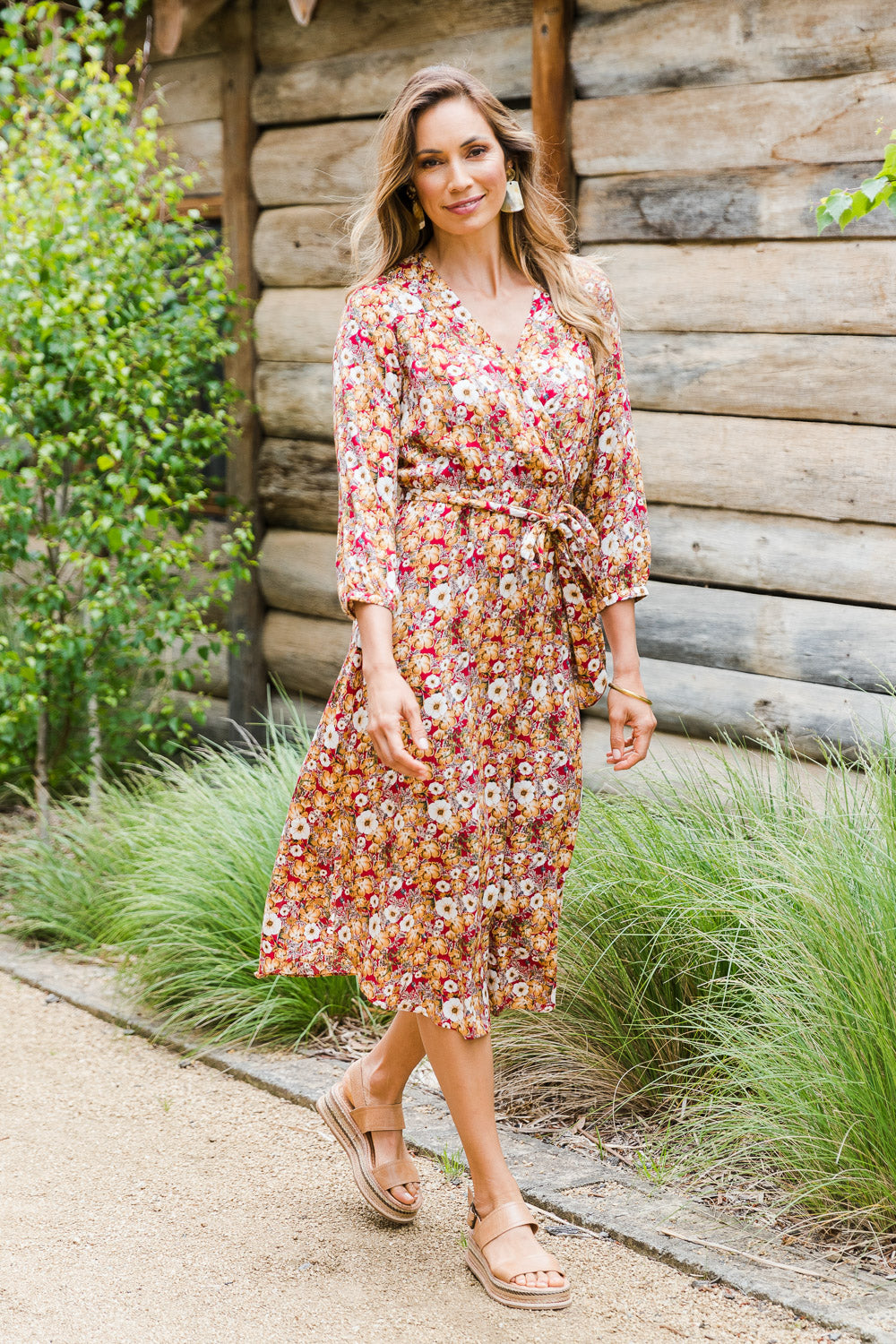 Model Amanda wearing size 10 of The Wrap Front Midi Dress in colour Redfloral (Red), from the front, showing the whole outfit