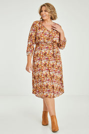 Model Fiona wearing size 16 of The Wrap Front Midi Dress in colour Redfloral (Red), from the front, showing the whole outfit