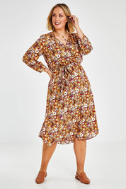 Model Jess wearing size 14 of The Wrap Front Midi Dress in colour Redfloral (Red), from the front, showing the whole outfit