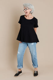 Model Elise wearing size 10 of The Short Sleeve Swing Tee in colour Black (Black), from the front, showing the whole outfit