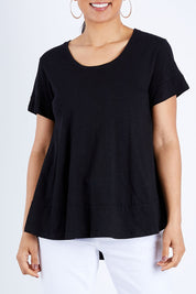 Model Pamela wearing size 10 of The Short Sleeve Swing Tee in colour Black (Black), from the front, cropped image