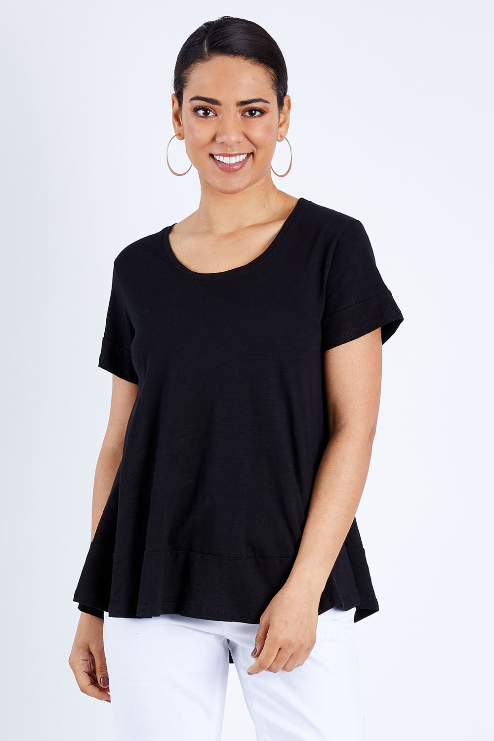 Model Pamela wearing size 10 of The Short Sleeve Swing Tee in colour Black (Black), from the front, cropped image