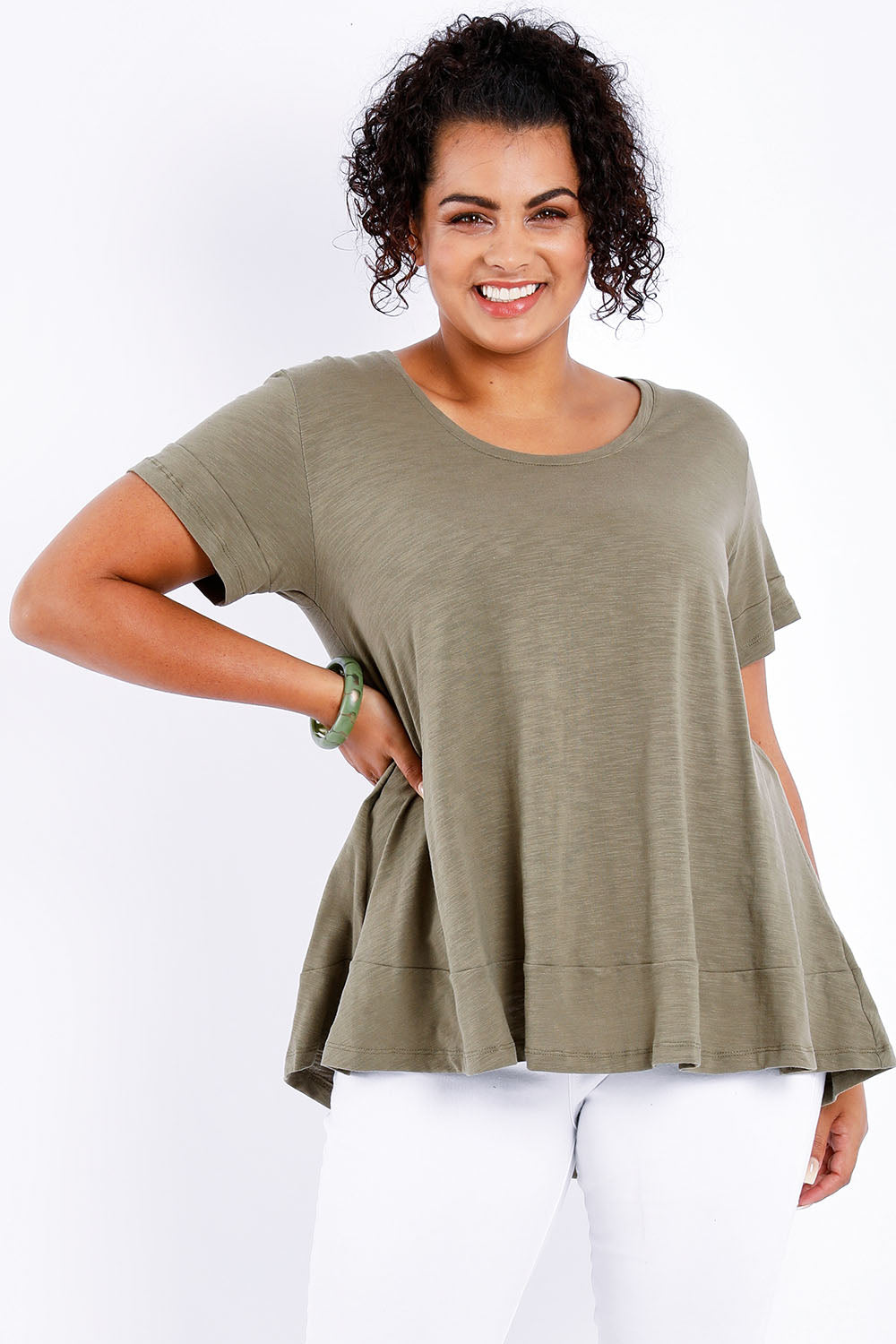 Model Sasha-Lee wearing size 16 of The Short Sleeve Swing Tee in colour Khaki (Green), from the front, cropped image
