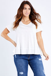 Model Laura wearing size 14 of The Short Sleeve Swing Tee in colour White (White), from the front, cropped image