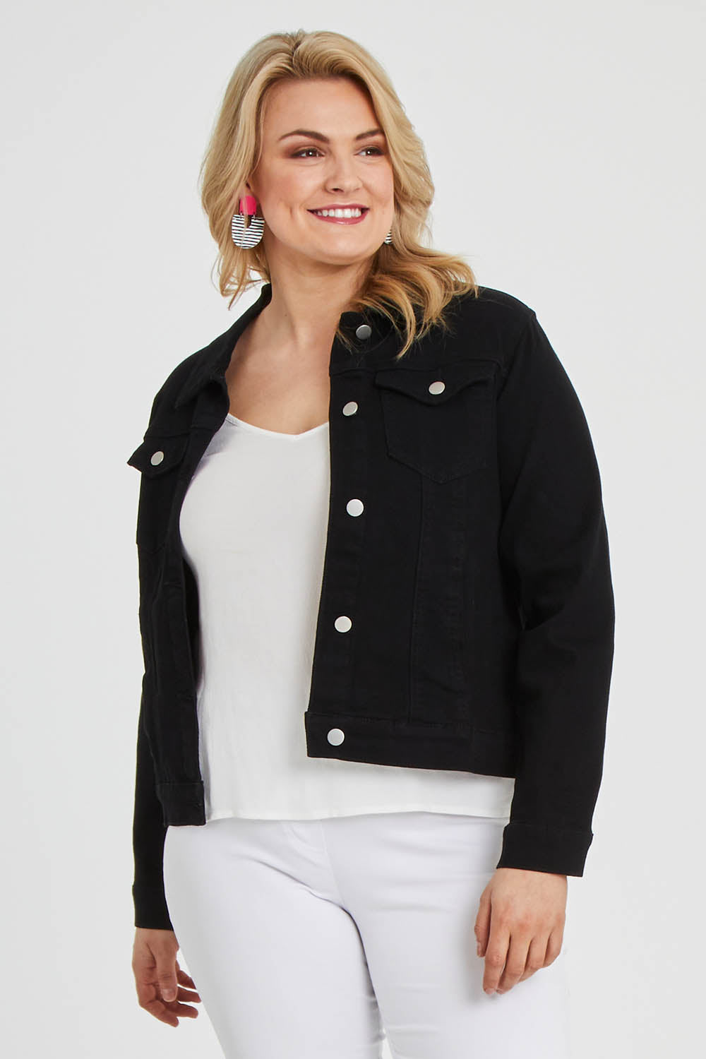 Model Keeara wearing size 16 of The Denim Jacket in colour Black (Black), from the front, cropped image