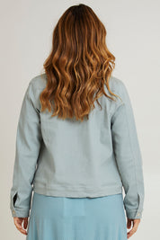 Model Laura wearing size 14 of The Denim Jacket in colour Seafoam (Green), from the back