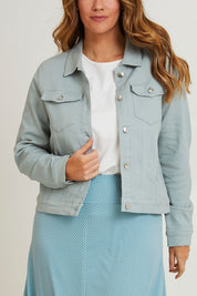 Model Laura wearing size 14 of The Denim Jacket in colour Seafoam (Green), from the front, cropped image