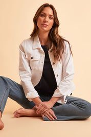 Model Madeline wearing size 10 of The Denim Jacket in colour Whitedenim (White), from the front, showing the whole outfit