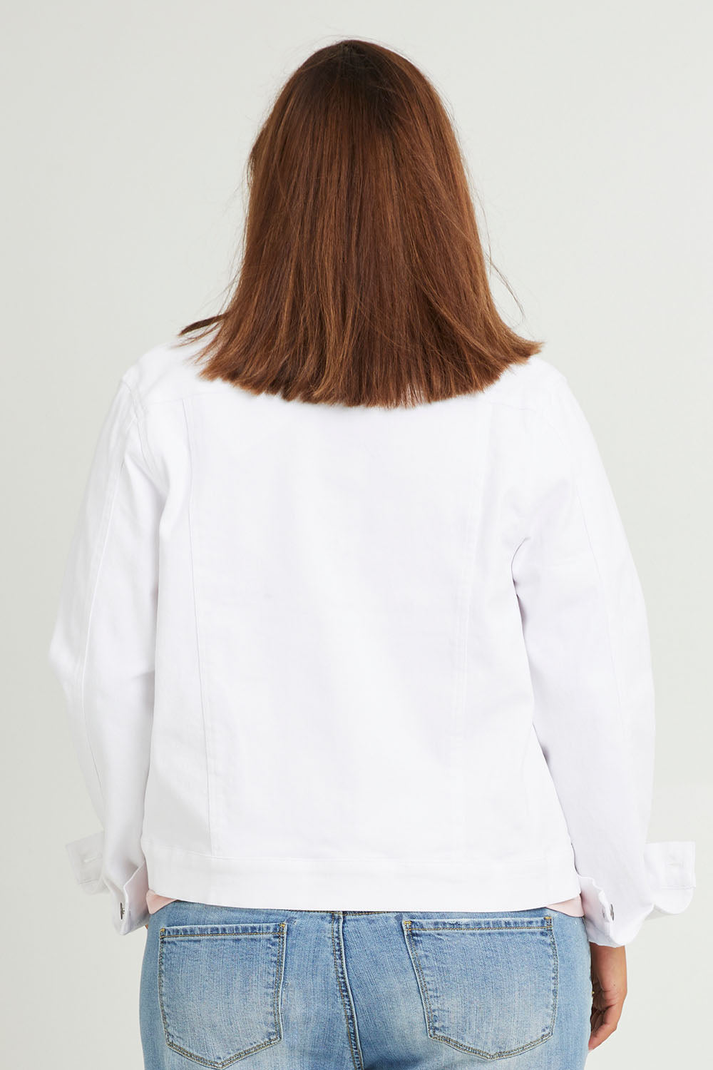 Model Monique wearing size 14 of The Denim Jacket in colour Whitedenim (White), from the back