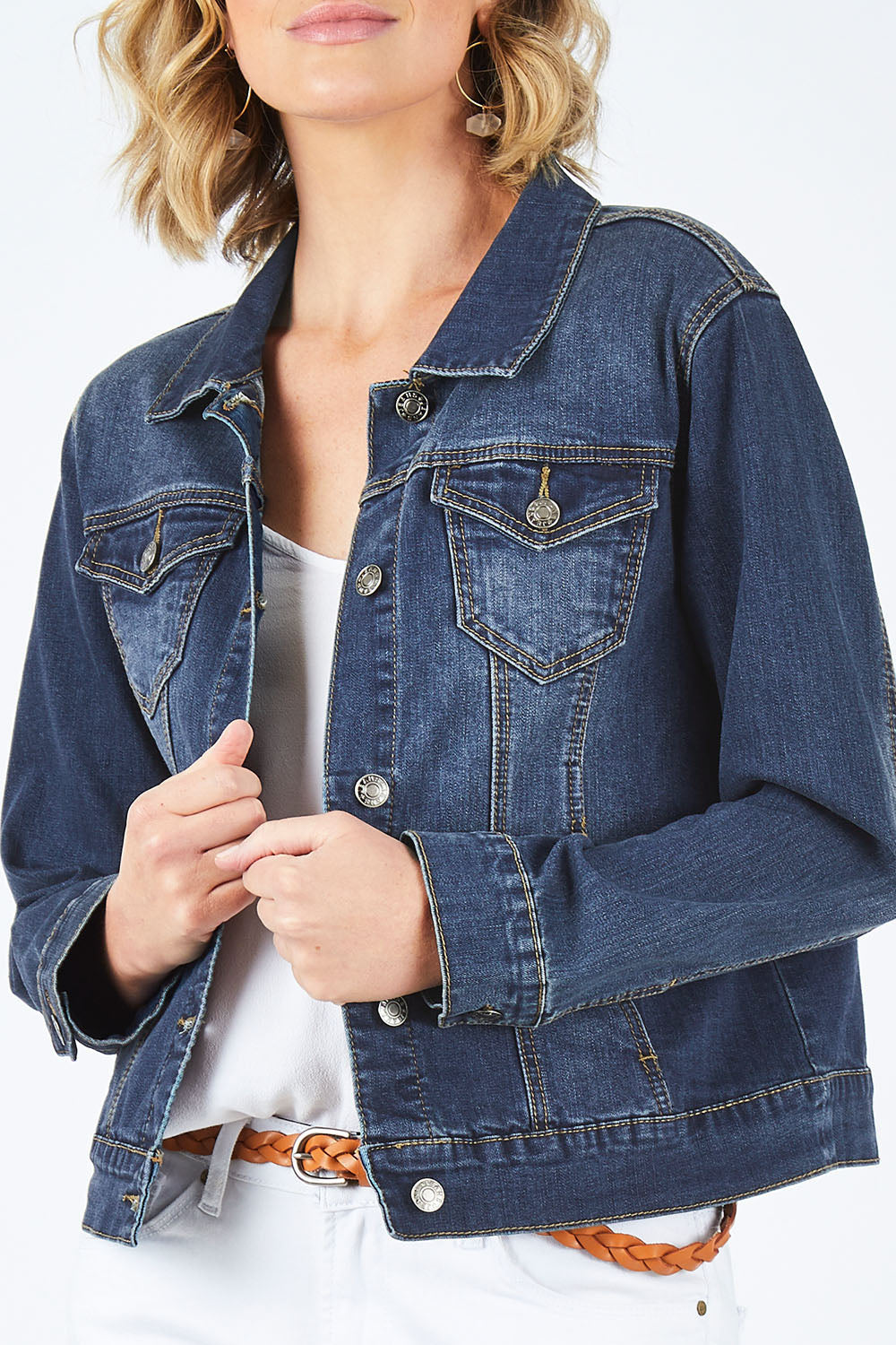 Model Chelsea wearing size 10 of The Denim Jacket in colour Denim (Blue), from the front, cropped image