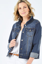 Model Chelsea wearing size 10 of The Denim Jacket in colour Denim (Blue), from the front, cropped image