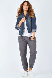 Model Laura wearing size 14 of The Denim Jacket in colour Denim (Blue), from the front, showing the whole outfit