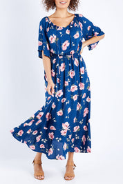 Model Lala wearing size 10 of The Printed Frill Detail Maxi in colour Pinkfloral (Pink), from the front, cropped image