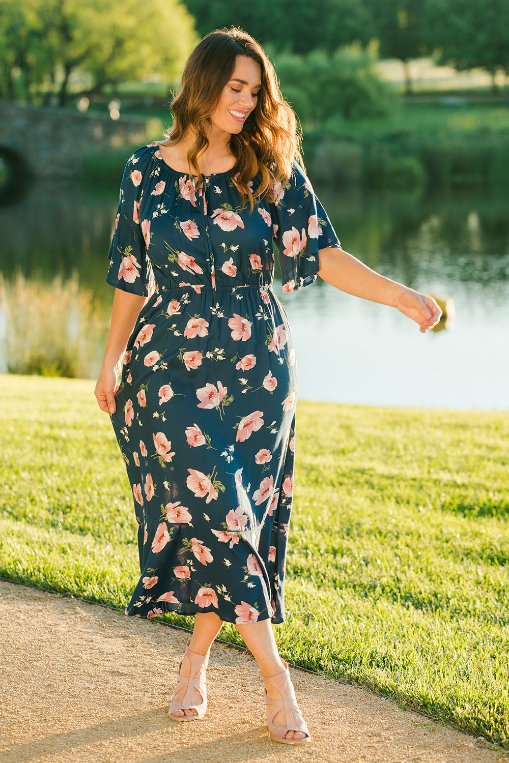 Model Laura wearing size 14 of The Printed Frill Detail Maxi in colour Pinkfloral (Pink), from the front, showing the whole outfit