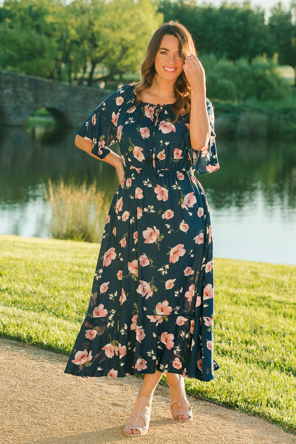 Model Laura wearing size 14 of The Printed Frill Detail Maxi in colour Pinkfloral (Pink), from the front, showing the whole outfit