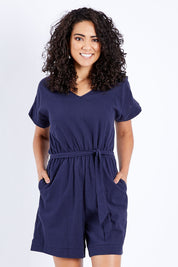Model Pamela wearing size 10 of The Upcycled Cotton Playsuit in colour Navy (Blue), from the front, cropped image