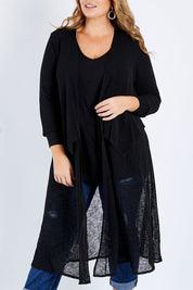 Model Fiona wearing size 16 of The Throw Over Duster Cardi in colour Black (Black), from the front, cropped image