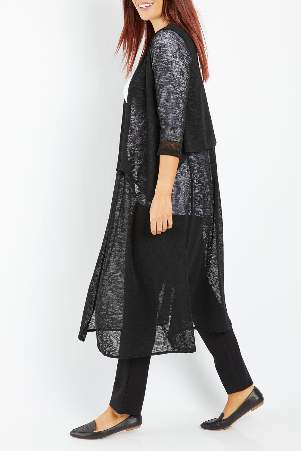 Model Laura wearing size 14 of The Throw Over Duster Cardi in colour Black (Black), from the front, cropped image
