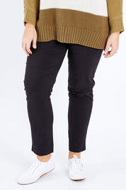 Model Fiona wearing size 16 of The Panel Detail Pant in colour Black (Black), from the front, cropped image