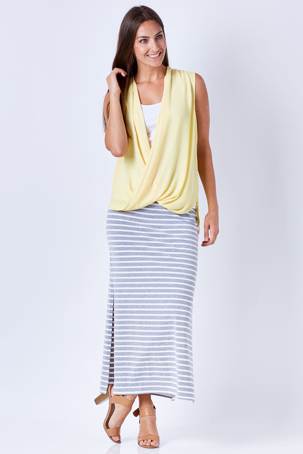 Model Anna wearing size 10 of The Sleeveless Cross Over Blouse in colour Sunshine, from the front, showing the whole outfit