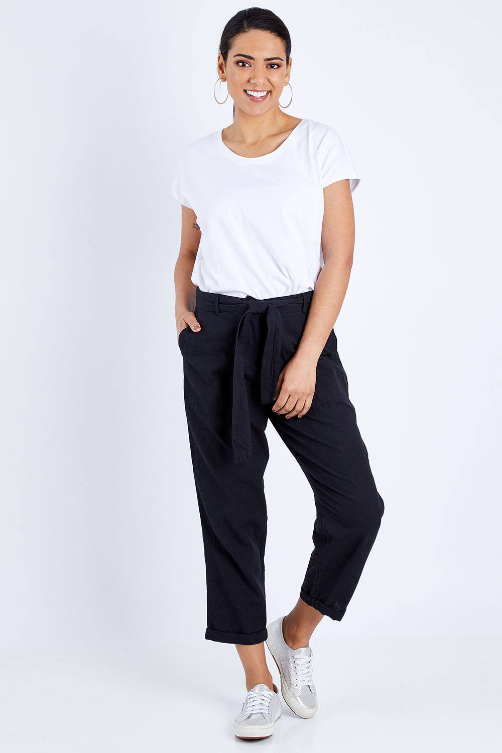 Model Pamela wearing size 10 of The Sash Detail Pant in colour Black (Black), from the front, showing the whole outfit