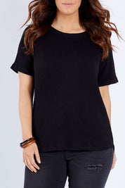 Model Laura wearing size 14 of The Essential Pleat Detail Tee in colour Black (Black), from the front, cropped image