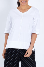 Model Pamela wearing size 10 of The Panel Detail Tee in colour White (White), from the front, cropped image