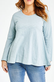 Model Laura wearing size 14 of The Long Sleeve Swing Tee in colour Chambray (Blue), from the front, cropped image