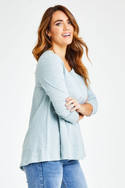Model Laura wearing size 14 of The Long Sleeve Swing Tee in colour Chambray (Blue), from the front, cropped image