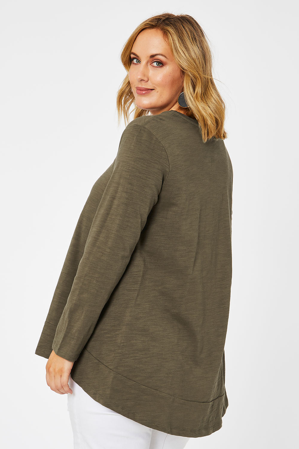 Model Jess wearing size 14 of The Long Sleeve Swing Tee in colour Khaki (Green), from the back