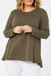 Model Jess wearing size 14 of The Long Sleeve Swing Tee in colour Khaki (Green), from the front, cropped image