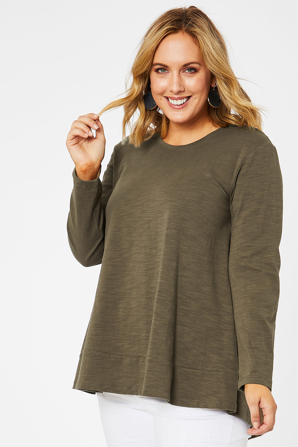 Model Jess wearing size 14 of The Long Sleeve Swing Tee in colour Khaki (Green), from the front, cropped image