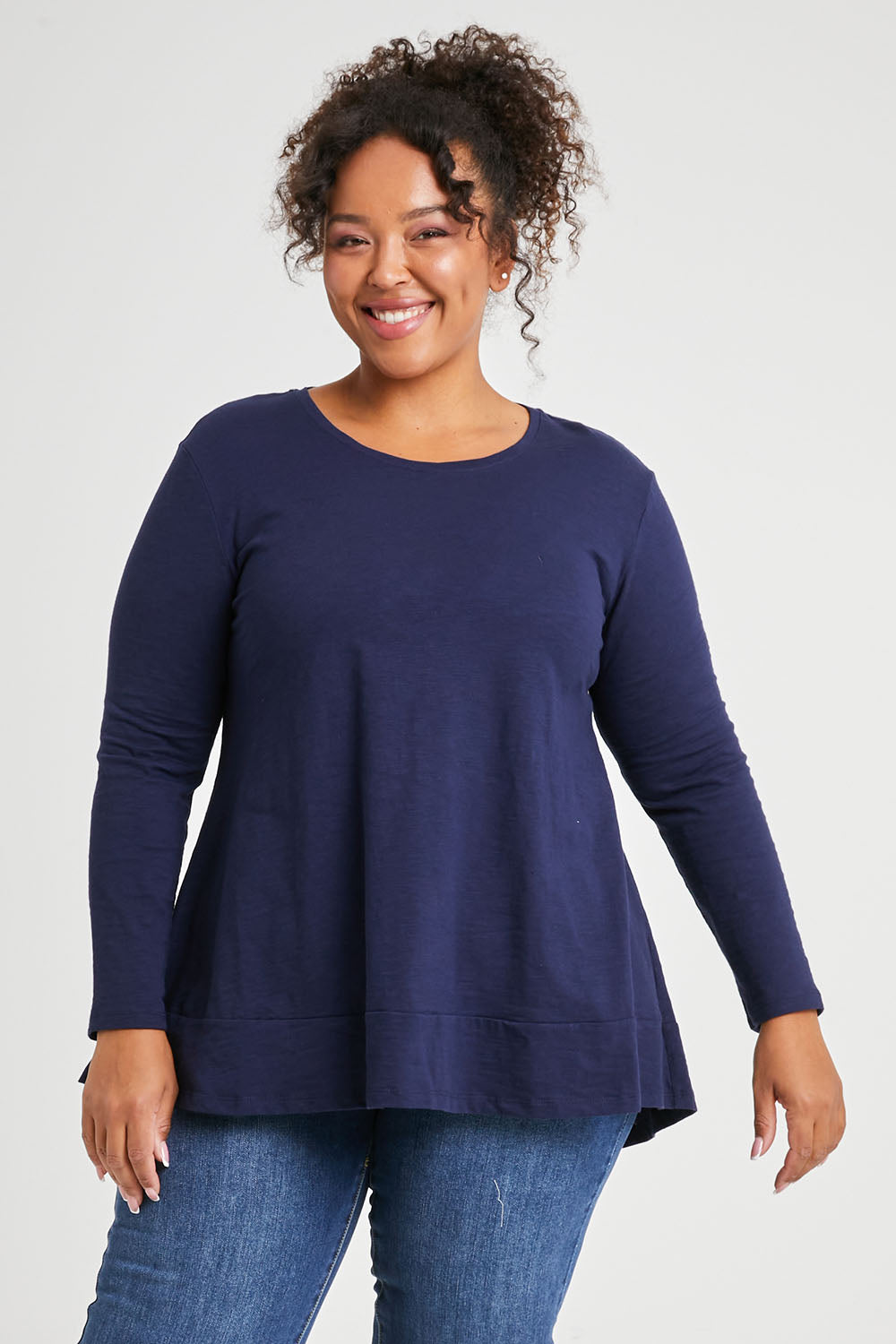 Model Alexis wearing size 16 of The Long Sleeve Swing Tee in colour Navy (Blue), from the front, cropped image