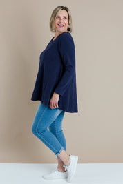 A model wearing size 16 of The Long Sleeve Swing Tee in colour Navy (Blue), from the front, showing the whole outfit