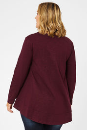 Model Jess wearing size 14 of The Long Sleeve Swing Tee in colour Shiraz (Red), from the back
