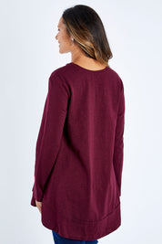 Model Kimberley wearing size 10 of The Long Sleeve Swing Tee in colour Shiraz (Red), from the back