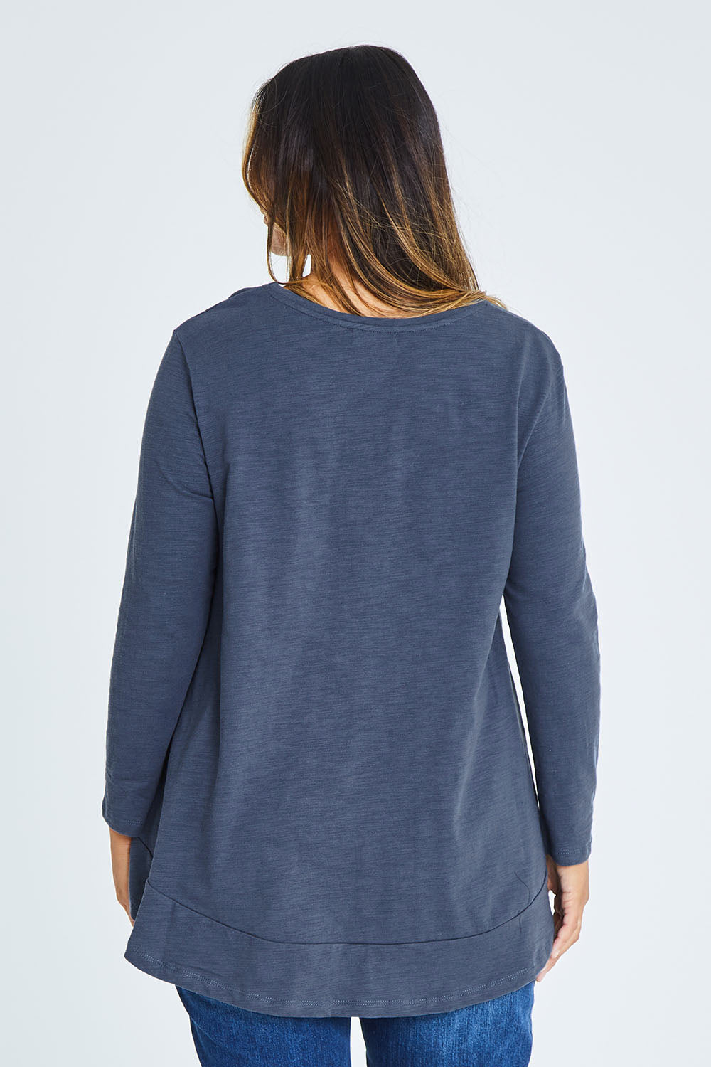 Model Palatina wearing size 16 of The Long Sleeve Swing Tee in colour Slate (Grey), from the back
