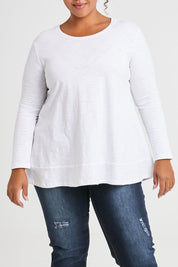 Model Alexis wearing size 16 of The Long Sleeve Swing Tee in colour White (White), from the front, cropped image