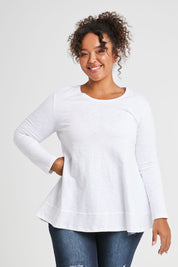 Model Alexis wearing size 16 of The Long Sleeve Swing Tee in colour White (White), from the front, cropped image