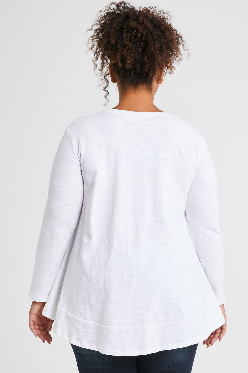 Model Alexis wearing size 16 of The Long Sleeve Swing Tee in colour White (White), from the front, cropped image