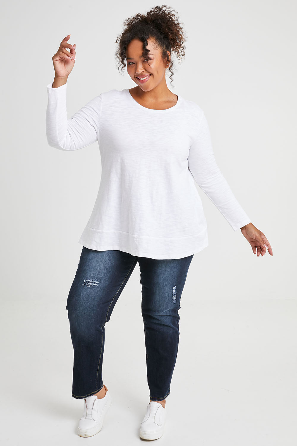 Model Alexis wearing size 16 of The Long Sleeve Swing Tee in colour White (White), from the front, showing the whole outfit