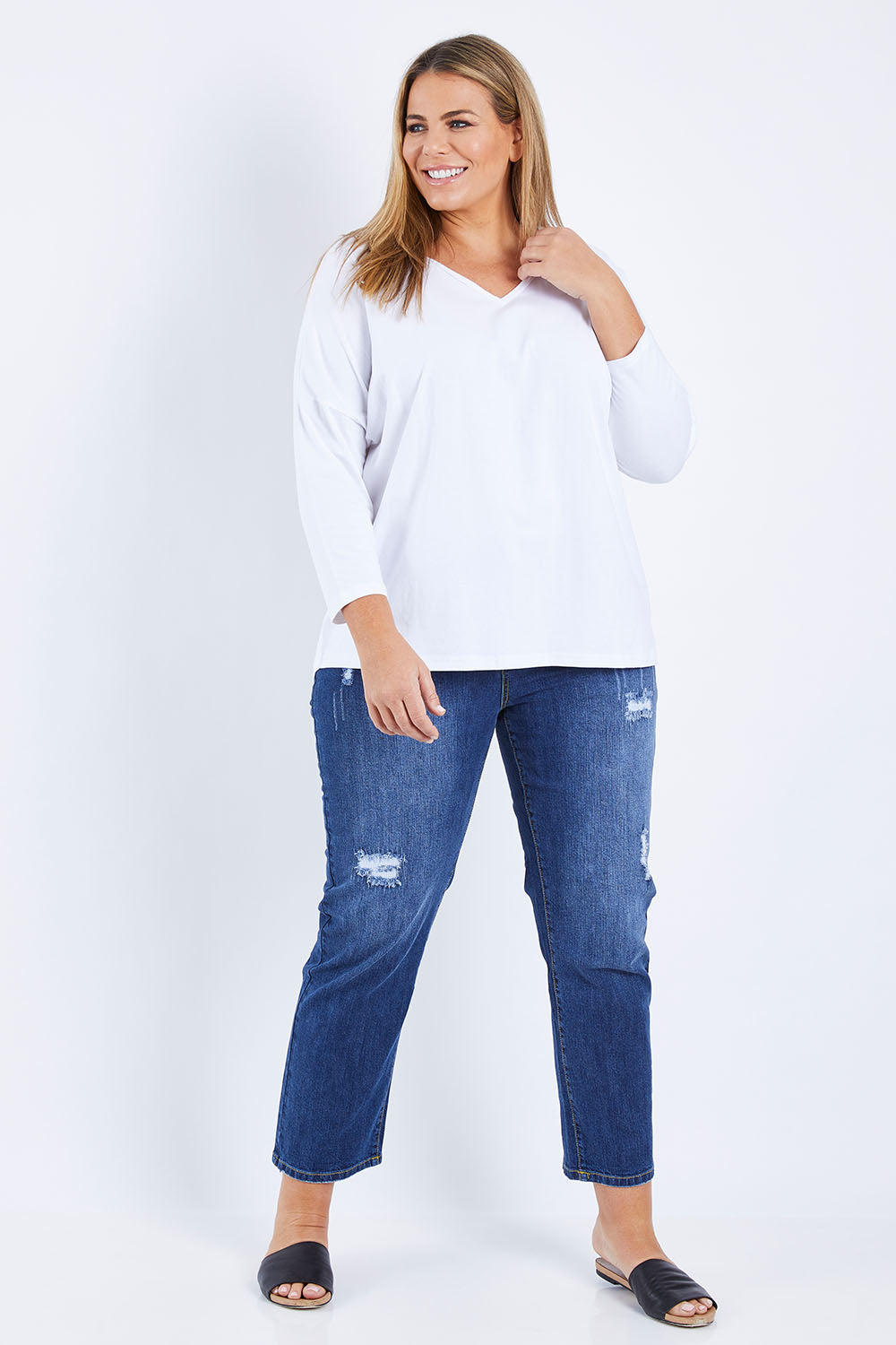 Model Fiona wearing size 16 of The V Neck Split Back Top in colour White (White), from the front, showing the whole outfit