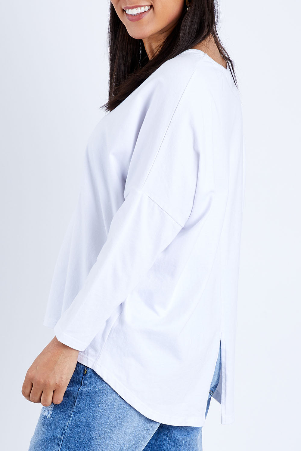 Model Pamela wearing size 10 of The V Neck Split Back Top in colour White (White), from the front, cropped image