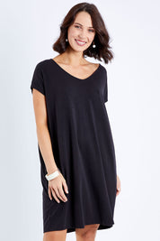 Model Andrea wearing size S of The Relaxed Jersey Dress in colour Black (Black), from the front, cropped image