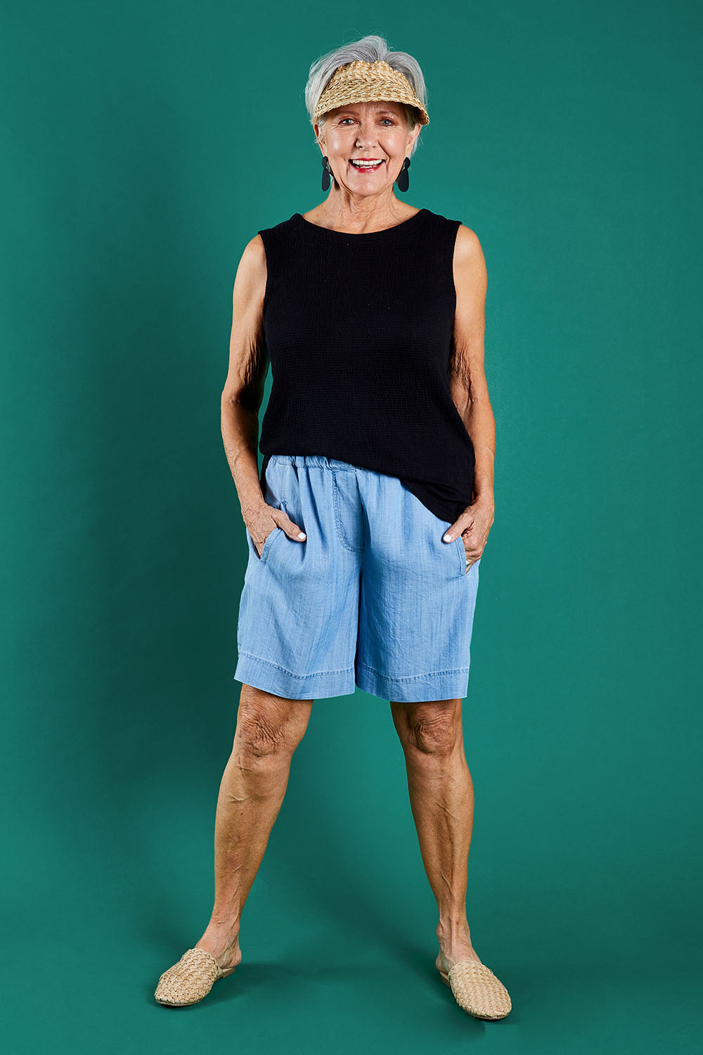 Model Elise wearing size 10 of The Chambray Walk Short in colour Chambray (Blue), from the front, showing the whole outfit