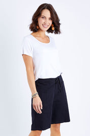 Model Andrea wearing size 10 of The Cotton Blend Walk Short in colour Black (Black), from the front, cropped image