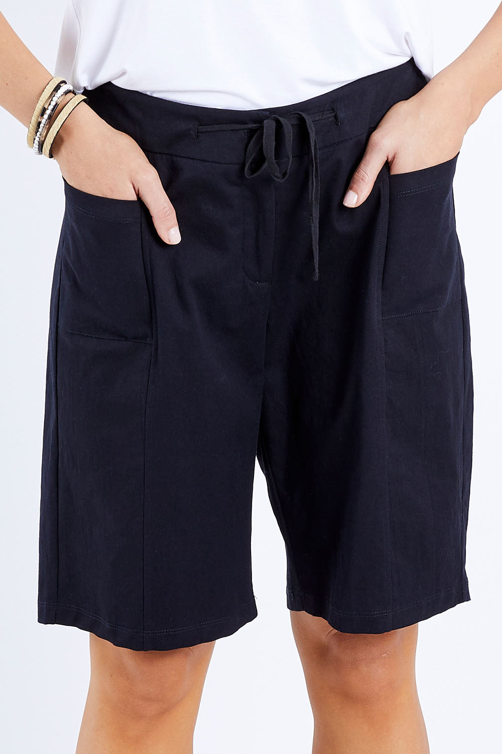 Model Andrea wearing size 10 of The Cotton Blend Walk Short in colour Black (Black), from the front, cropped image
