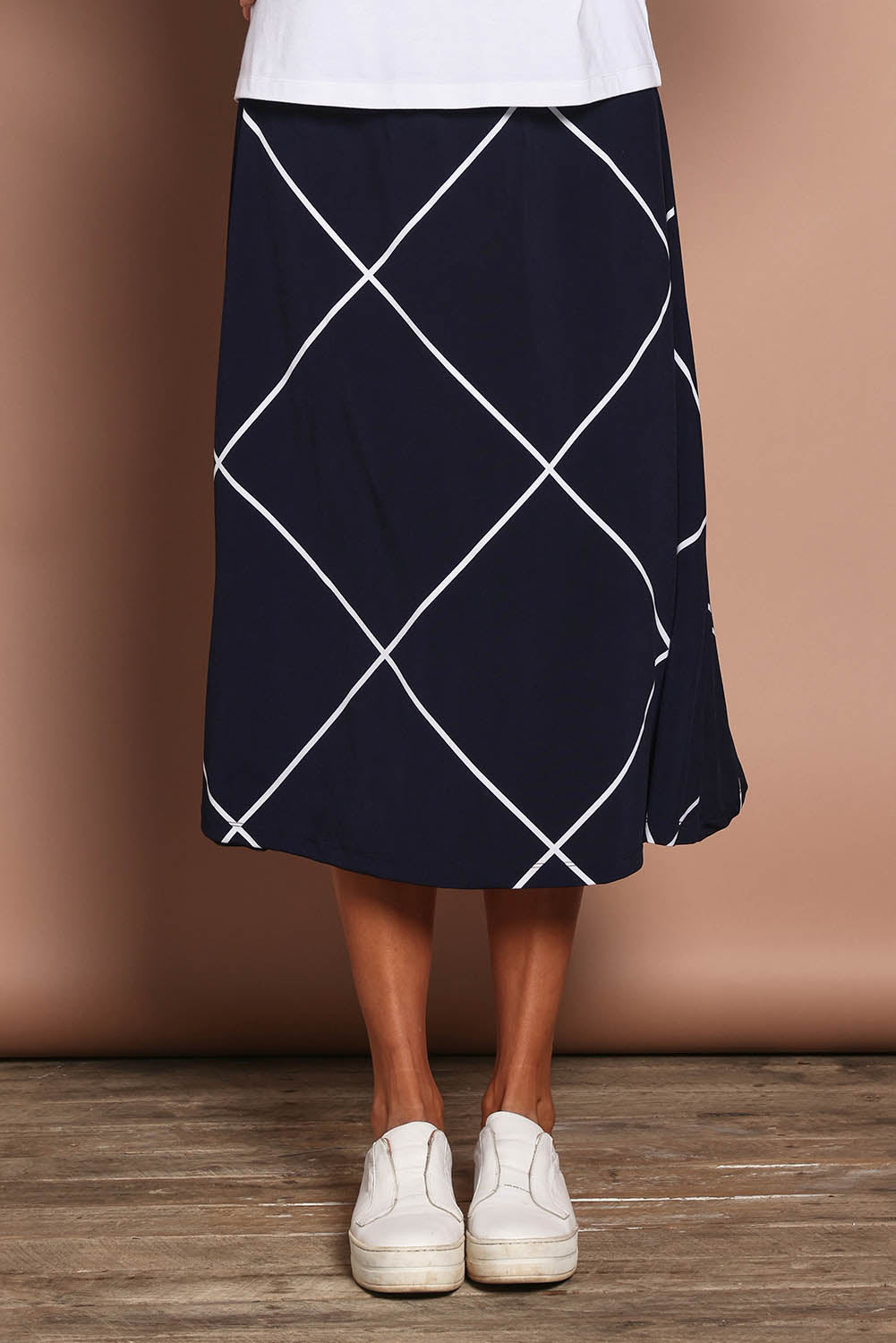 Model Amanda wearing size 10 of The Pull On Skirt in colour Navywhite (Blue), from the front, cropped image