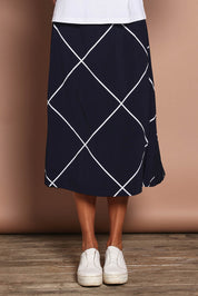 Model Amanda wearing size 10 of The Pull On Skirt in colour Navywhite (Blue), from the front, cropped image